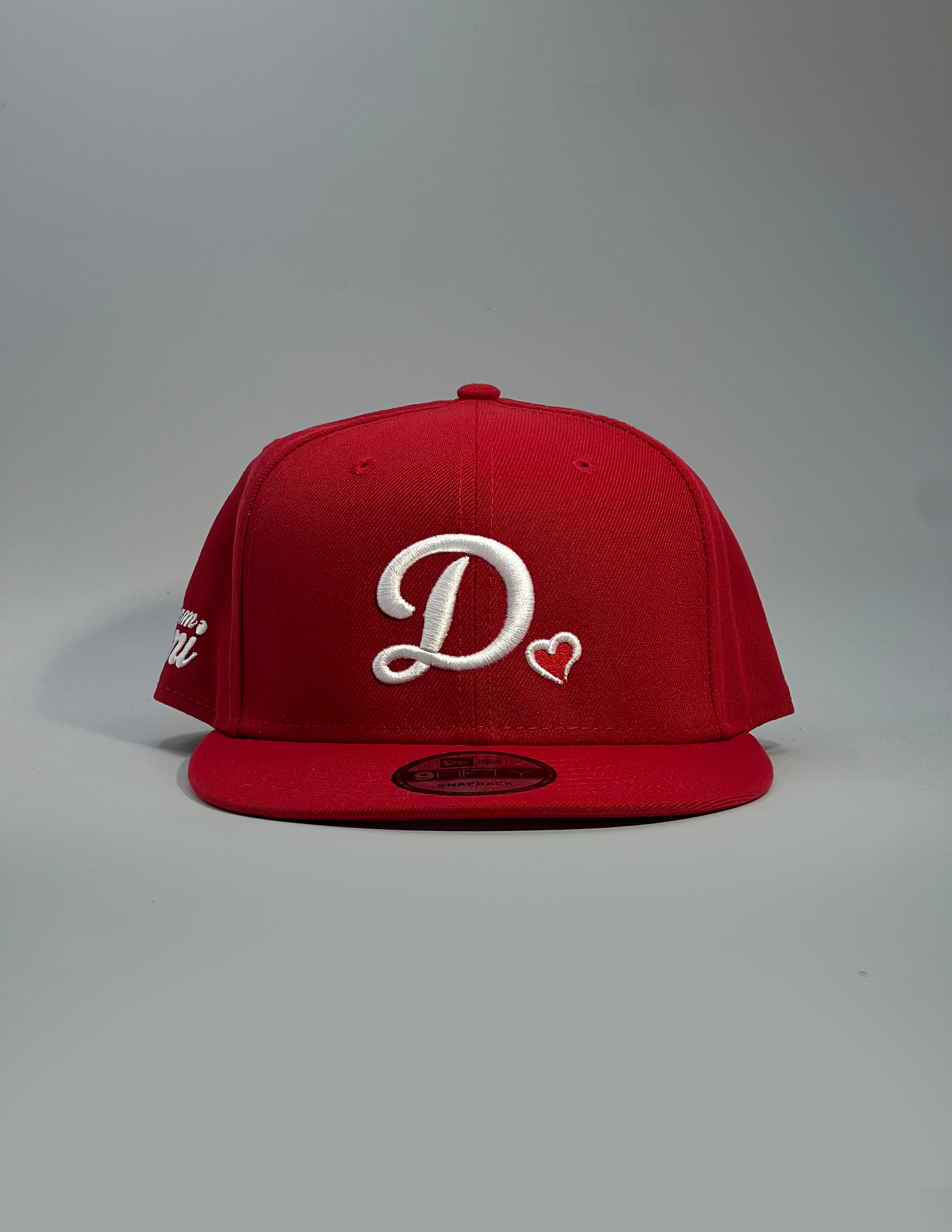 Red cap with a white D❤️logo on a gray background