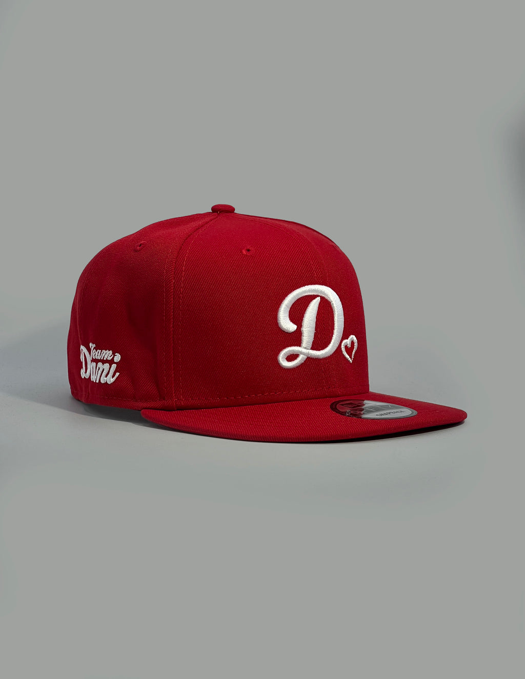 Red cap with white D❤️logo on a gray background